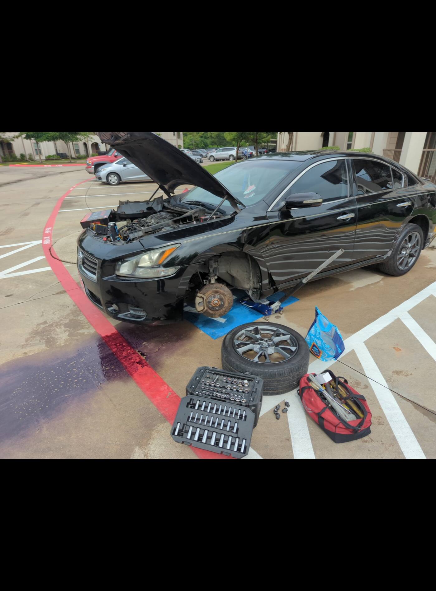 Mobile mechanic working on a vehicle on location